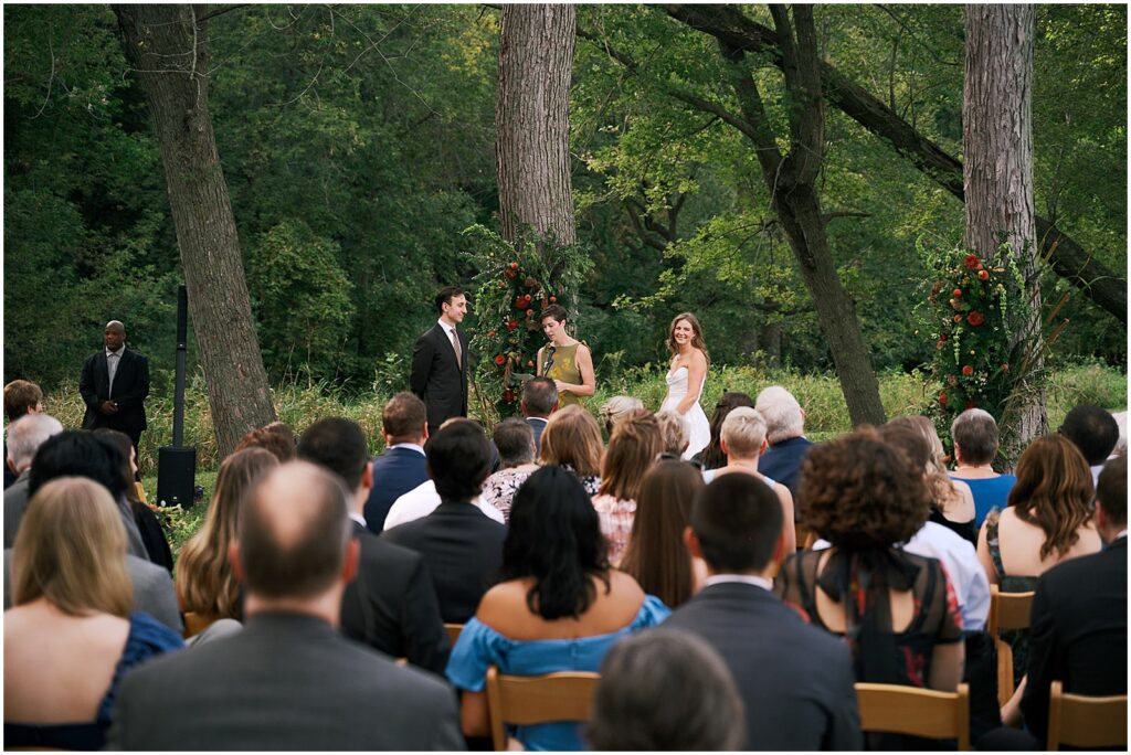 Wedding guests sit and watch a ceremony at a private estate in Iowa City.