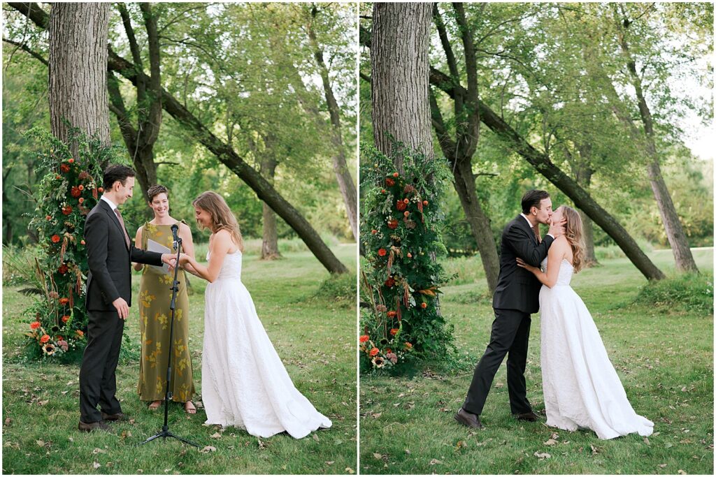 A bride and groom kiss at the end of their outdoor ceremony at an Iowa City wedding.