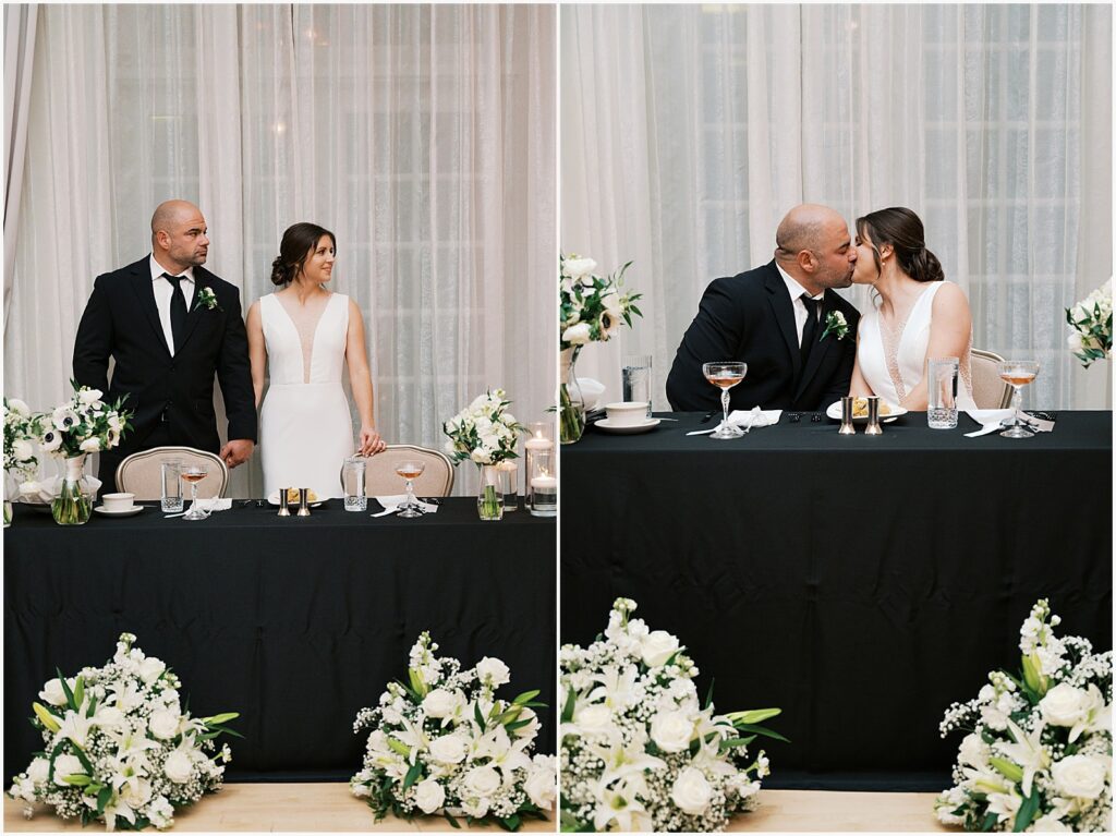 A bride and groom kiss at a sweetheart table at Hotel Fort Des Moines.