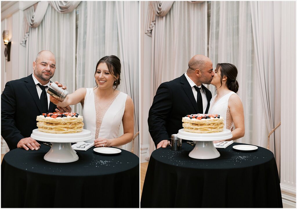 A bride and groom kiss beside a wedding cake in a ballroom in Hotel Fort Des Moines.