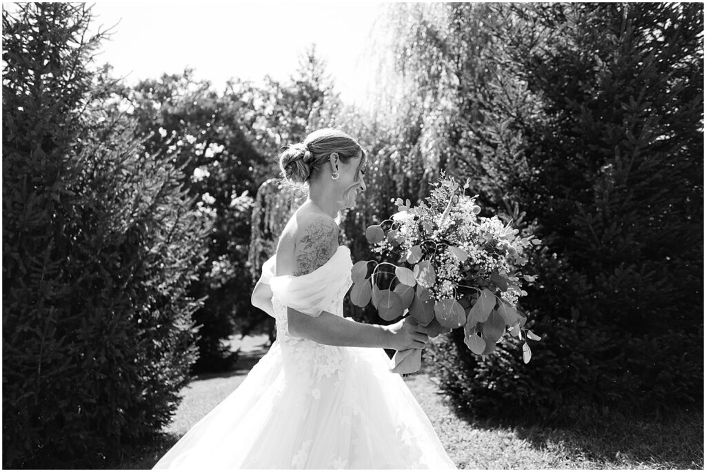 A bride holds a bouquet in a candid wedding photo in Iowa City.