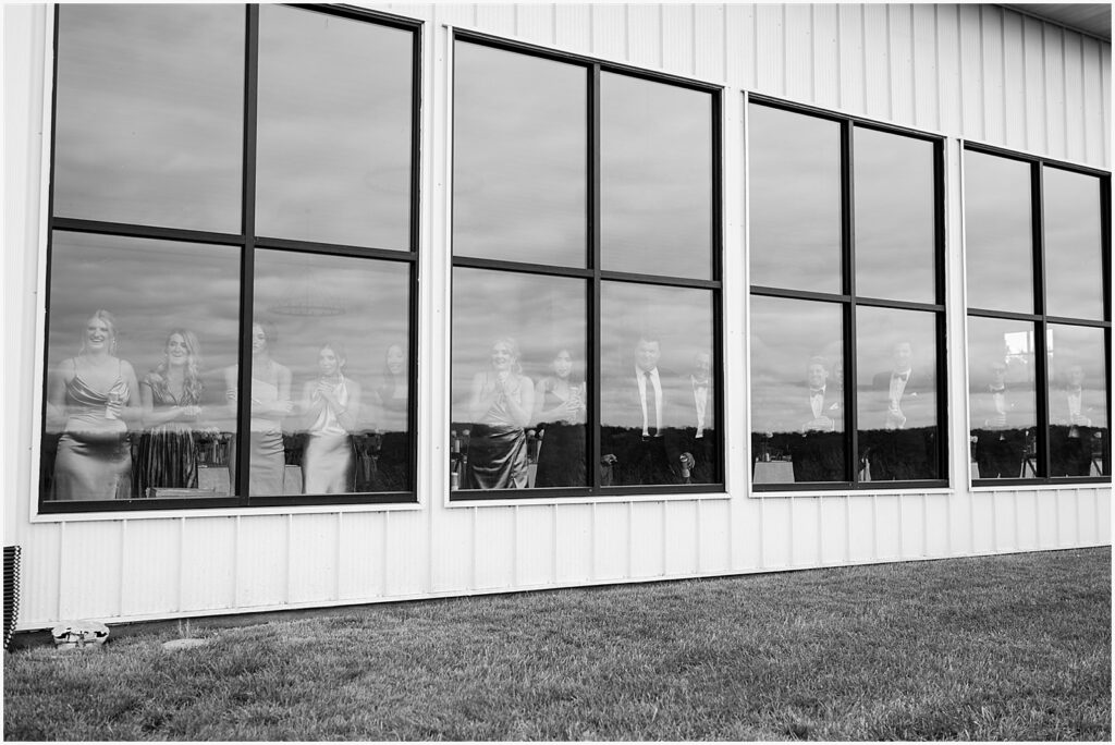 Guests look out the window of a reception hall at Ashton Hill Galena.