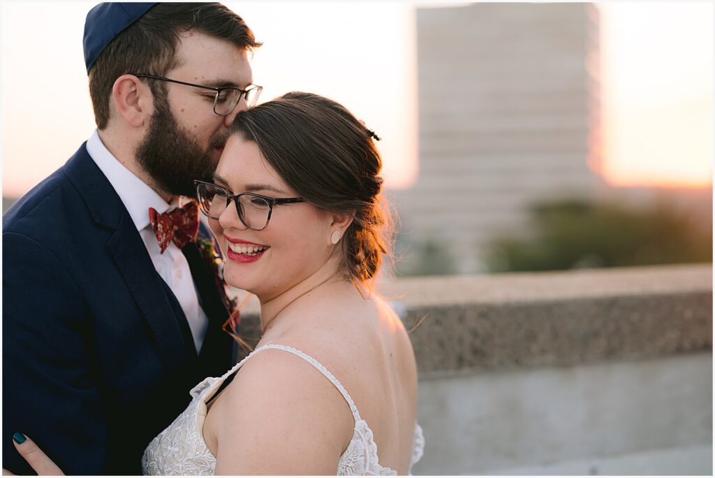 A bride and groom smile on an Eastern Iowa wedding venue's rooftop.