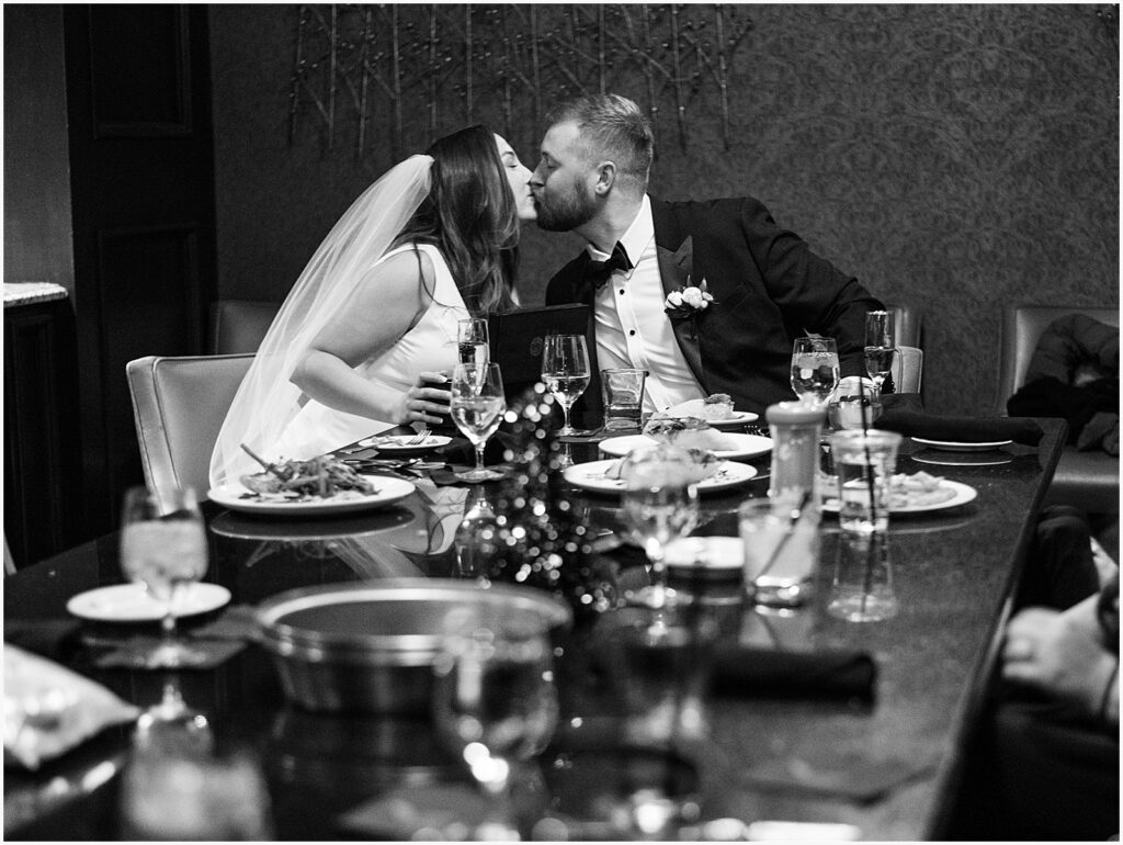 A bride and groom sit at a table in an Eastern Iowa hotel restaurant.