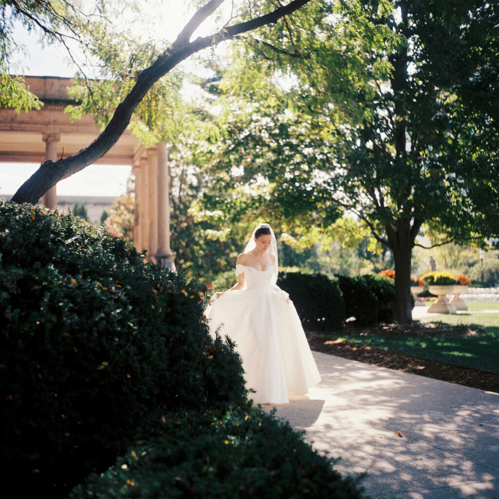 Bride walks on the lawn of the World Food Prize Hall